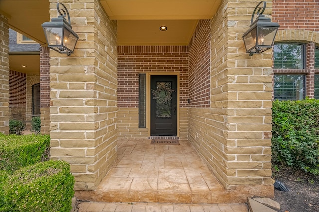 doorway to property featuring brick siding