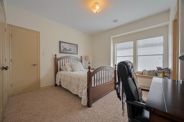 bedroom with visible vents, baseboards, and light carpet
