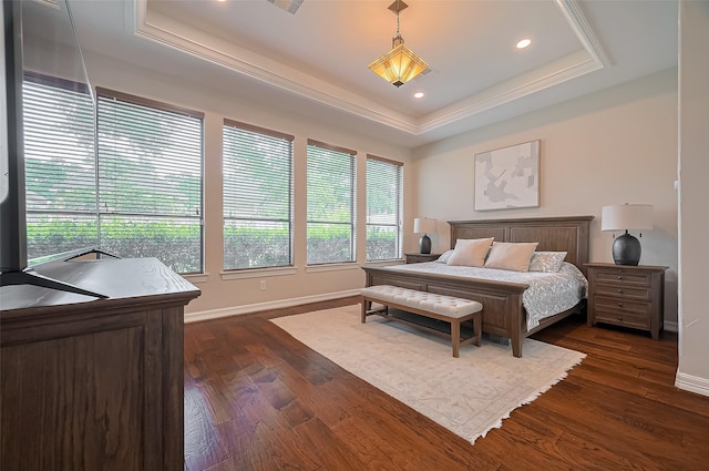 bedroom with dark wood-style flooring, a tray ceiling, recessed lighting, and baseboards