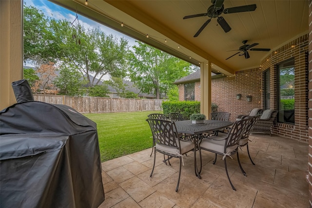 view of patio with a ceiling fan, a fenced backyard, grilling area, and outdoor dining space