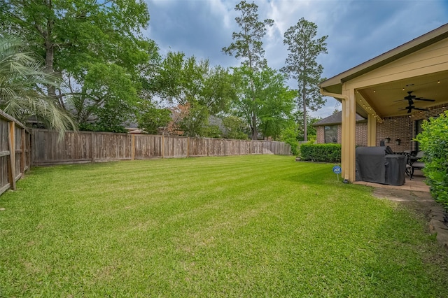 view of yard featuring a patio, a ceiling fan, and a fenced backyard