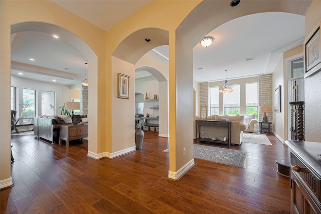 interior space with dark wood-style flooring, baseboards, visible vents, and a wealth of natural light