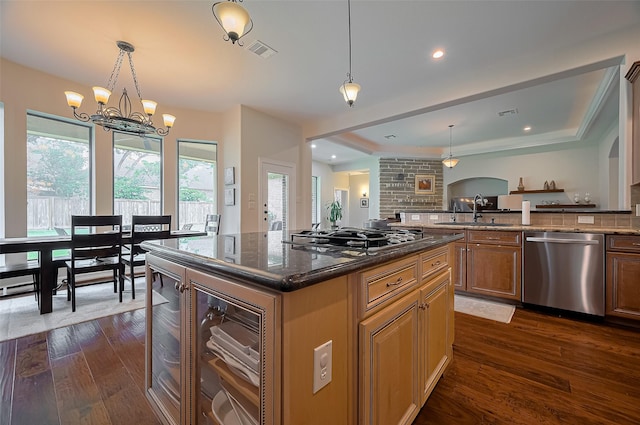 kitchen featuring gas cooktop, visible vents, stainless steel dishwasher, a sink, and a notable chandelier