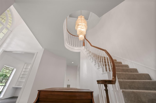 803 Mahogany Run Dr, Katy, TX 77494 - staircase featuring a towering ceiling, a chandelier, and arched walkways