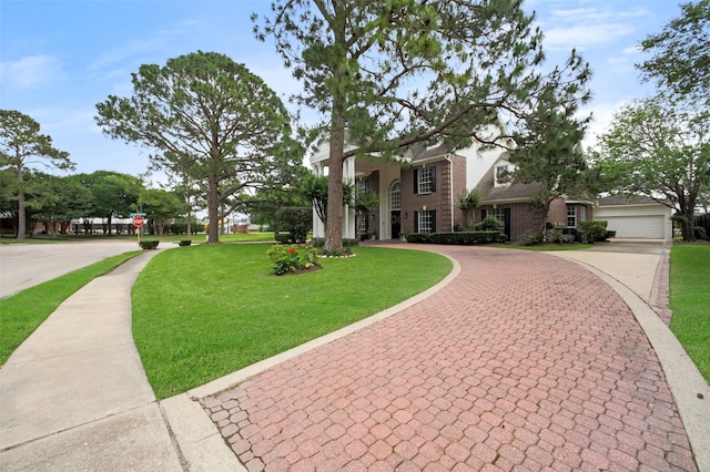803 Mahogany Run Dr, Katy, TX 77494 - view of front of house featuring curved driveway, a front yard, and brick siding