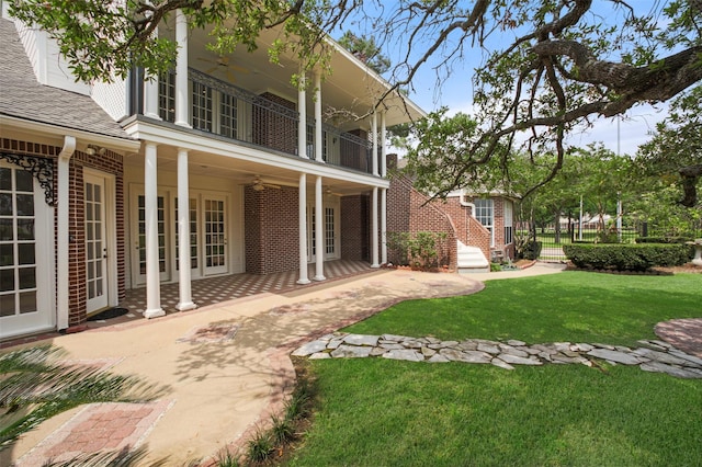803 Mahogany Run Dr, Katy, TX 77494 - back of house featuring brick siding, french doors, a balcony, and a patio area