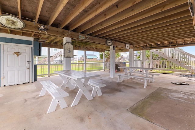 13114 Coronado Dr, Freeport, TX 77541 - view of patio / terrace featuring fence, stairway, and outdoor dining space