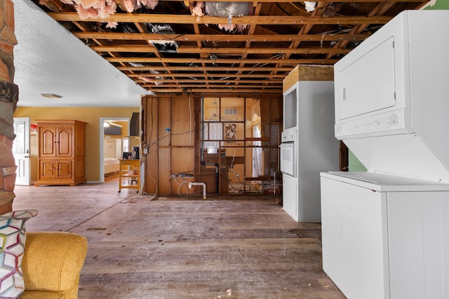 13114 Coronado Dr, Freeport, TX 77541 - interior space featuring stacked washing maching and dryer
