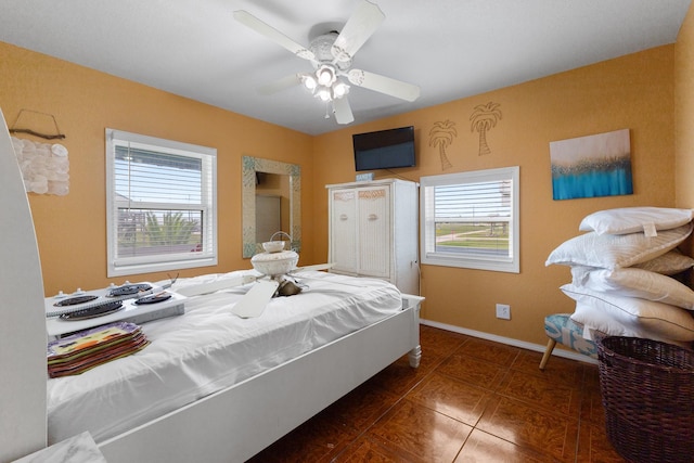 13114 Coronado Dr, Freeport, TX 77541 - tiled bedroom featuring baseboards and ceiling fan