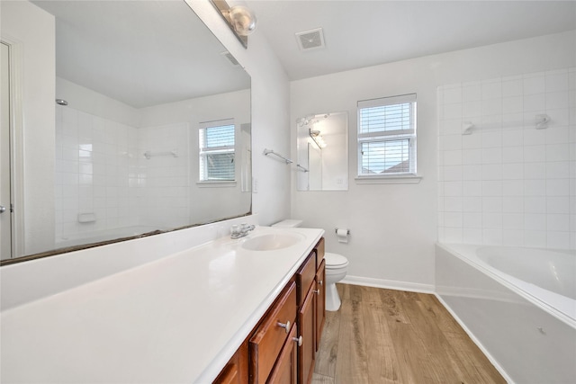 13003 Brutus Hill Ln, Houston, TX 77072 - full bathroom with visible vents, vanity, wood finished floors, toilet, and baseboards