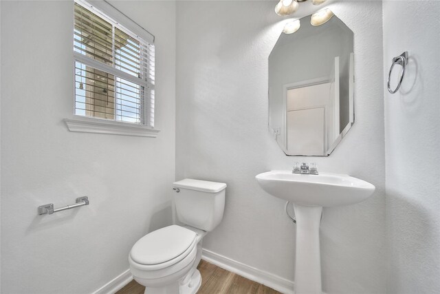 13003 Brutus Hill Ln, Houston, TX 77072 - half bathroom with a sink, baseboards, toilet, and wood finished floors