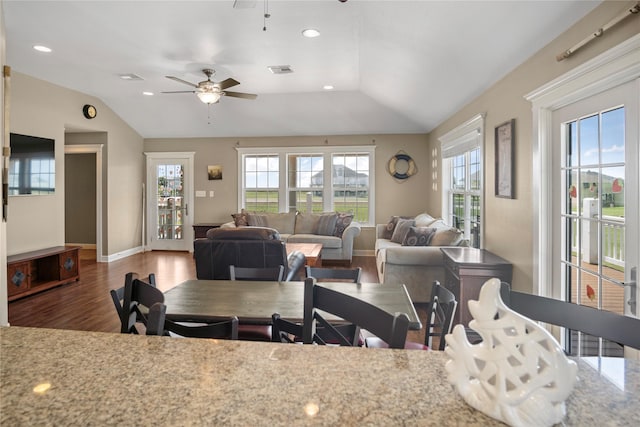 dining space with ceiling fan, vaulted ceiling, wood finished floors, and a wealth of natural light