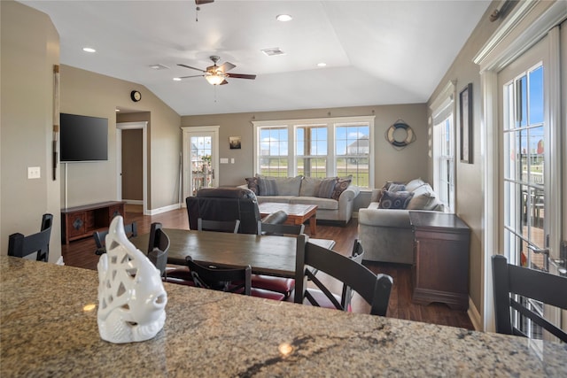 dining space featuring visible vents, wood finished floors, and vaulted ceiling