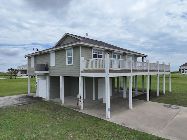 824 Rancho Caribe Dr, Port Bolivar, TX 77650 - rear view of house featuring a lawn, a carport, driveway, and an attached garage