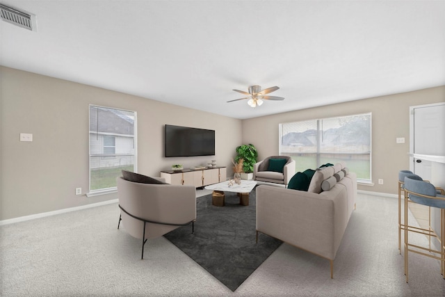 living area featuring carpet floors, a wealth of natural light, and visible vents