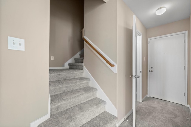 stairs featuring baseboards and carpet flooring