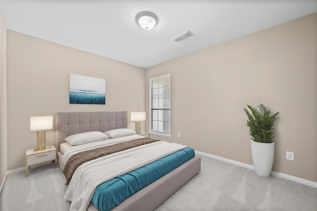 carpeted bedroom featuring baseboards and visible vents