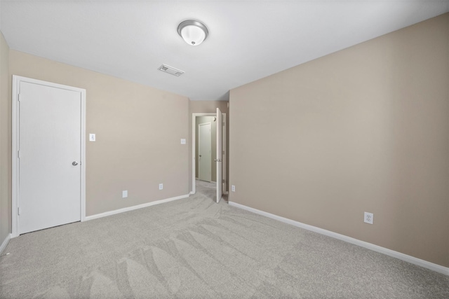 empty room with baseboards, carpet, and visible vents