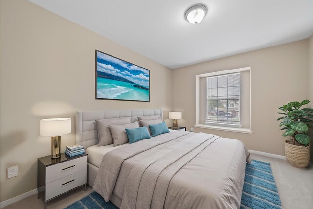 carpeted bedroom featuring baseboards
