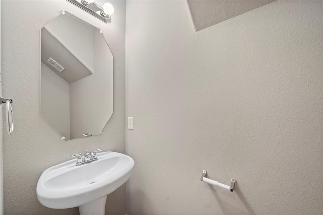 bathroom featuring visible vents and a sink