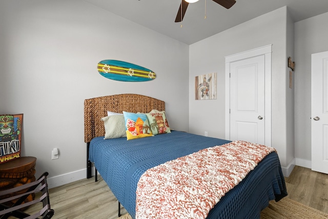 bedroom featuring baseboards, ceiling fan, and wood finished floors