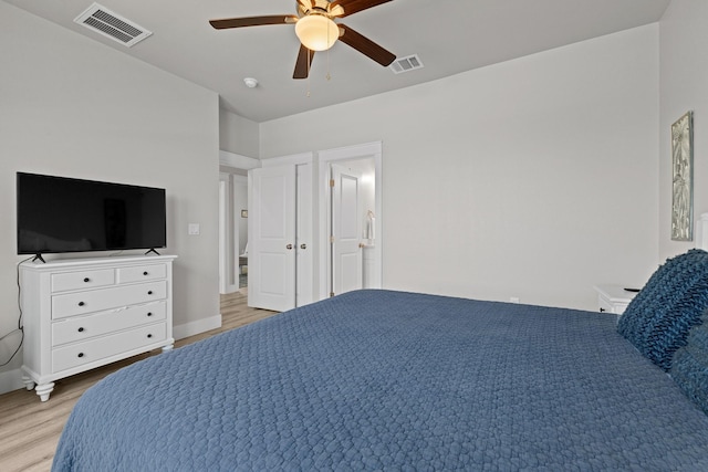 bedroom featuring ceiling fan, visible vents, baseboards, and light wood-style floors