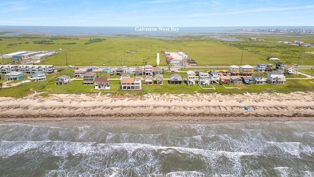 aerial view featuring a view of the beach and a water view