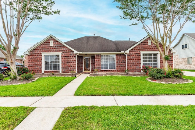 view of front of property with brick siding and a front lawn