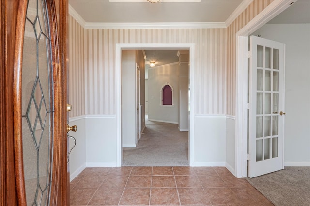 interior space featuring carpet floors, ornamental molding, and wallpapered walls
