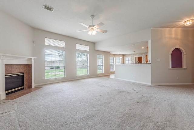 unfurnished living room featuring a ceiling fan, baseboards, visible vents, and carpet