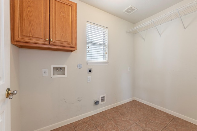 clothes washing area with baseboards, hookup for a washing machine, electric dryer hookup, cabinet space, and hookup for a gas dryer
