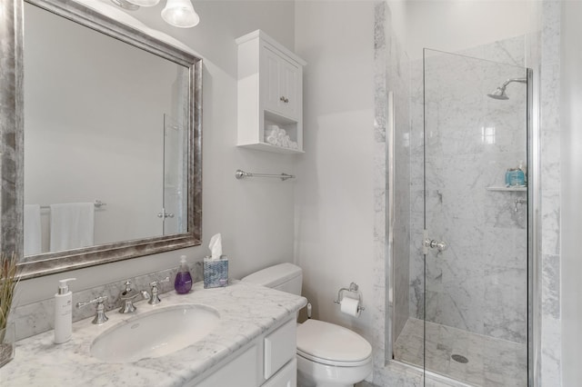 full bathroom with toilet, a marble finish shower, and vanity