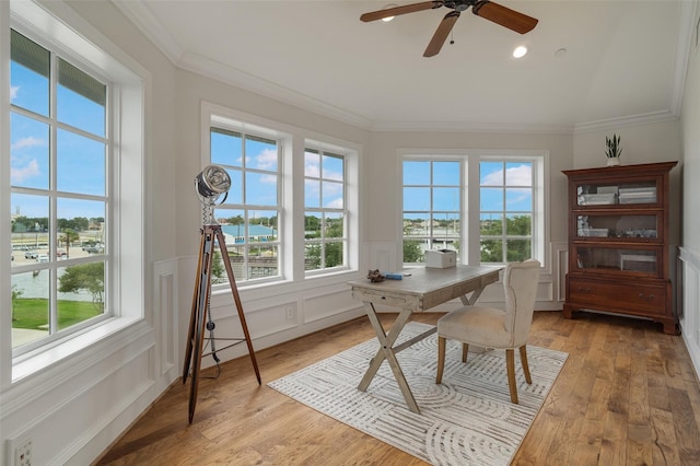sunroom featuring a water view