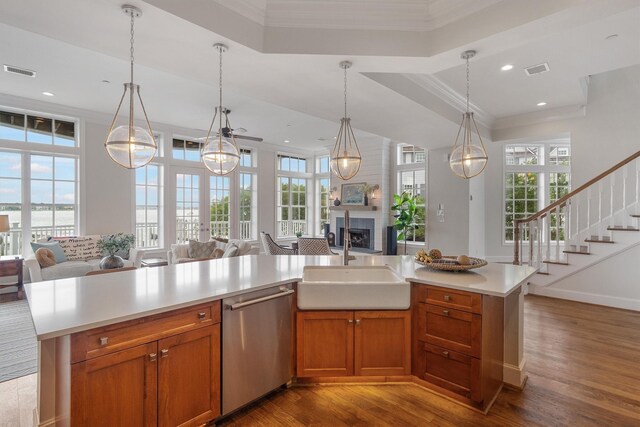 kitchen featuring a sink, dishwasher, light countertops, open floor plan, and visible vents