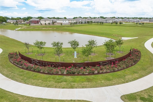 surrounding community featuring a residential view, a water view, and a lawn