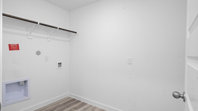 laundry room featuring washer hookup, laundry area, baseboards, and light wood-style flooring