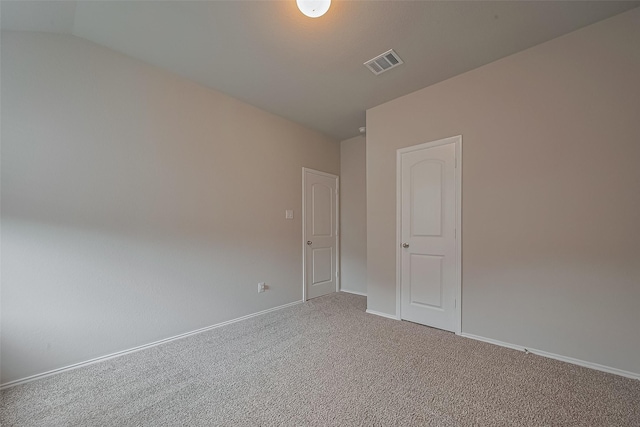 spare room with carpet floors, baseboards, and visible vents