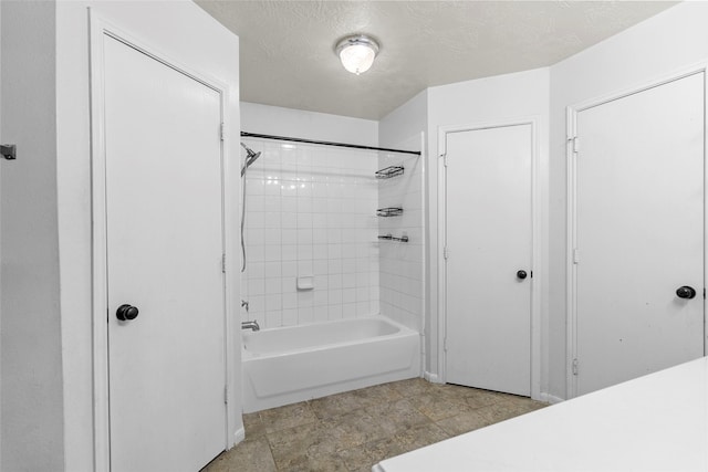bathroom featuring shower / bath combination and a textured ceiling