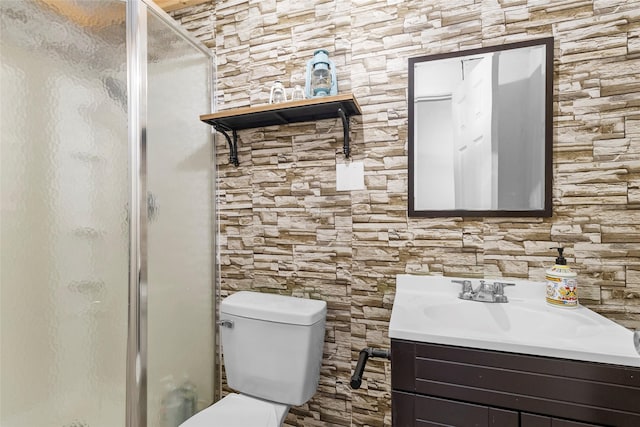 bathroom with vanity, a stall shower, and toilet