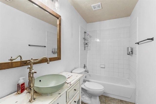 bathroom featuring vanity, toilet, a textured ceiling, shower / bathing tub combination, and visible vents
