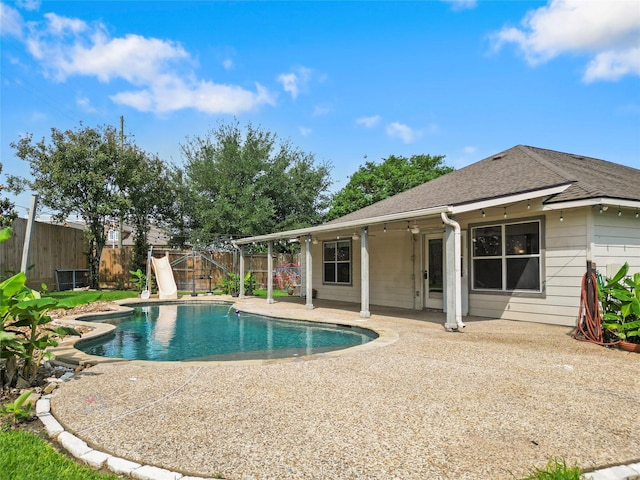 view of pool featuring a fenced backyard, a fenced in pool, a patio, and a water slide