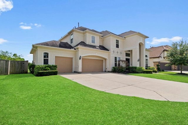 view of front of property featuring fence, driveway, a front lawn, and stucco siding