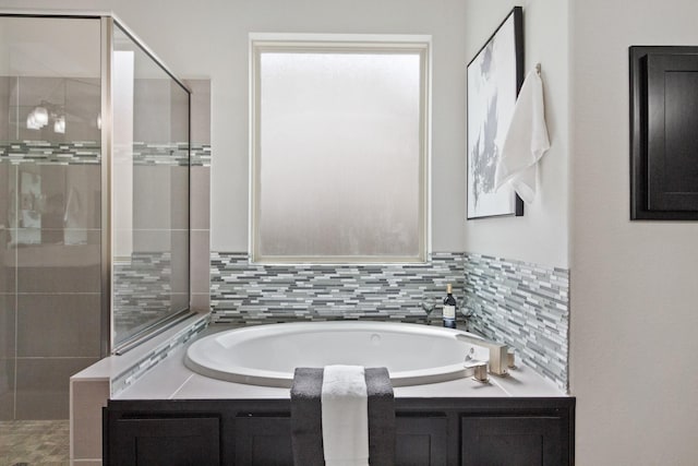 bathroom featuring a bath and a stall shower