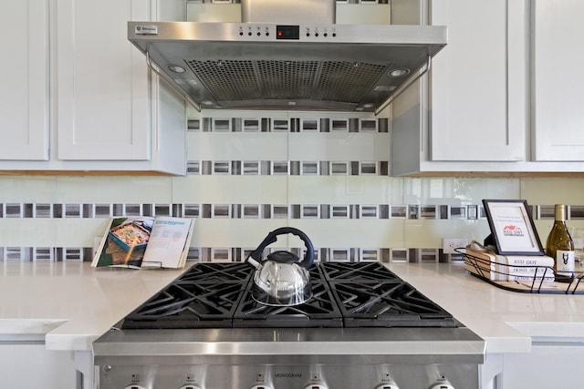 details with light countertops, decorative backsplash, white cabinets, and under cabinet range hood