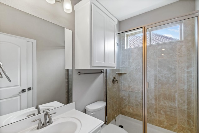 full bath featuring toilet, a shower stall, and vanity