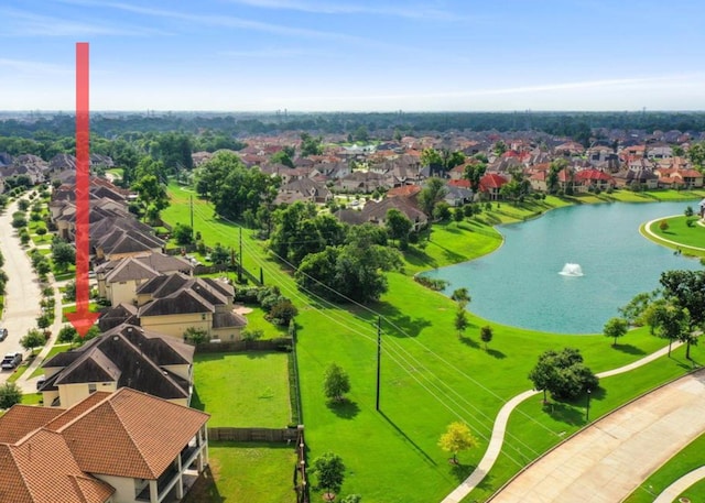 drone / aerial view featuring a residential view and a water view
