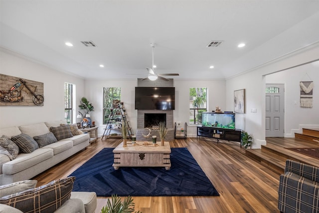 living area with visible vents and wood finished floors