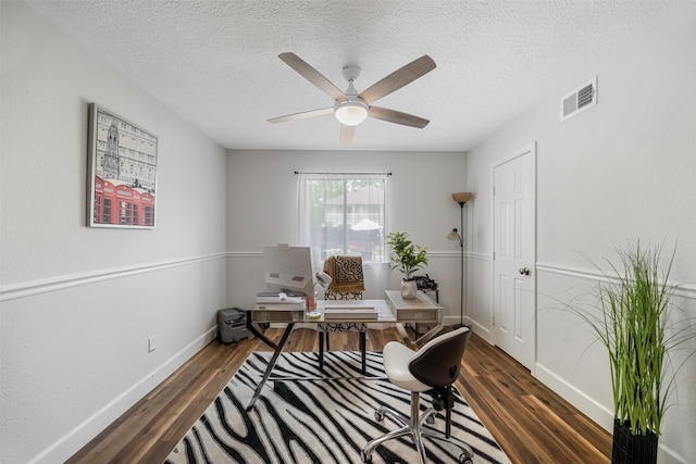 office area featuring visible vents, wood finished floors, baseboards, a textured ceiling, and a ceiling fan