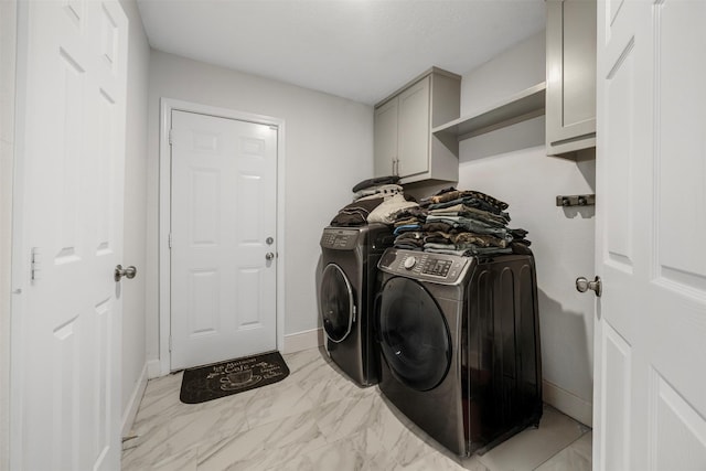 washroom with separate washer and dryer, baseboards, cabinet space, and marble finish floor