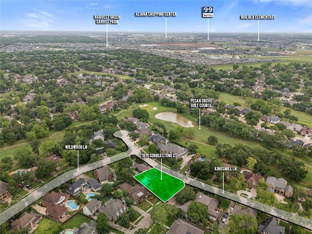 drone / aerial view with a residential view and golf course view